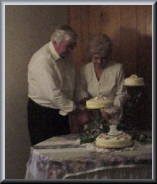 John and Sammie cutting the wedding cake